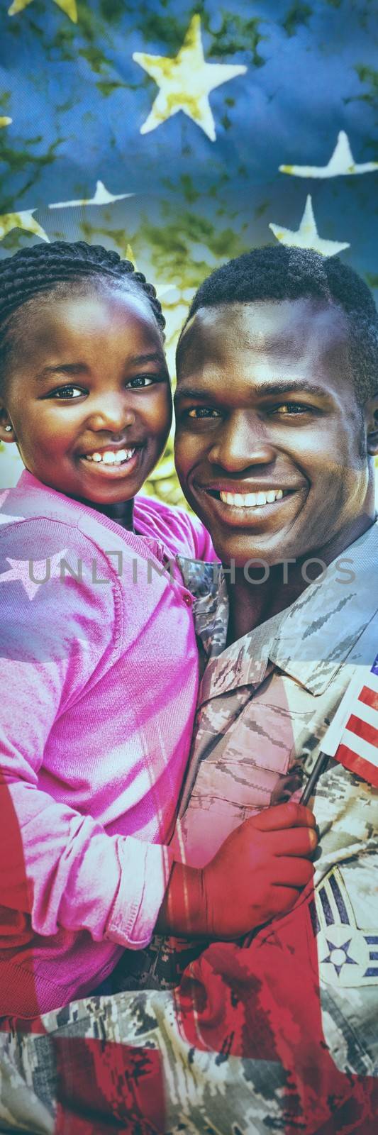 Close-up of an American flag against happy family posing together