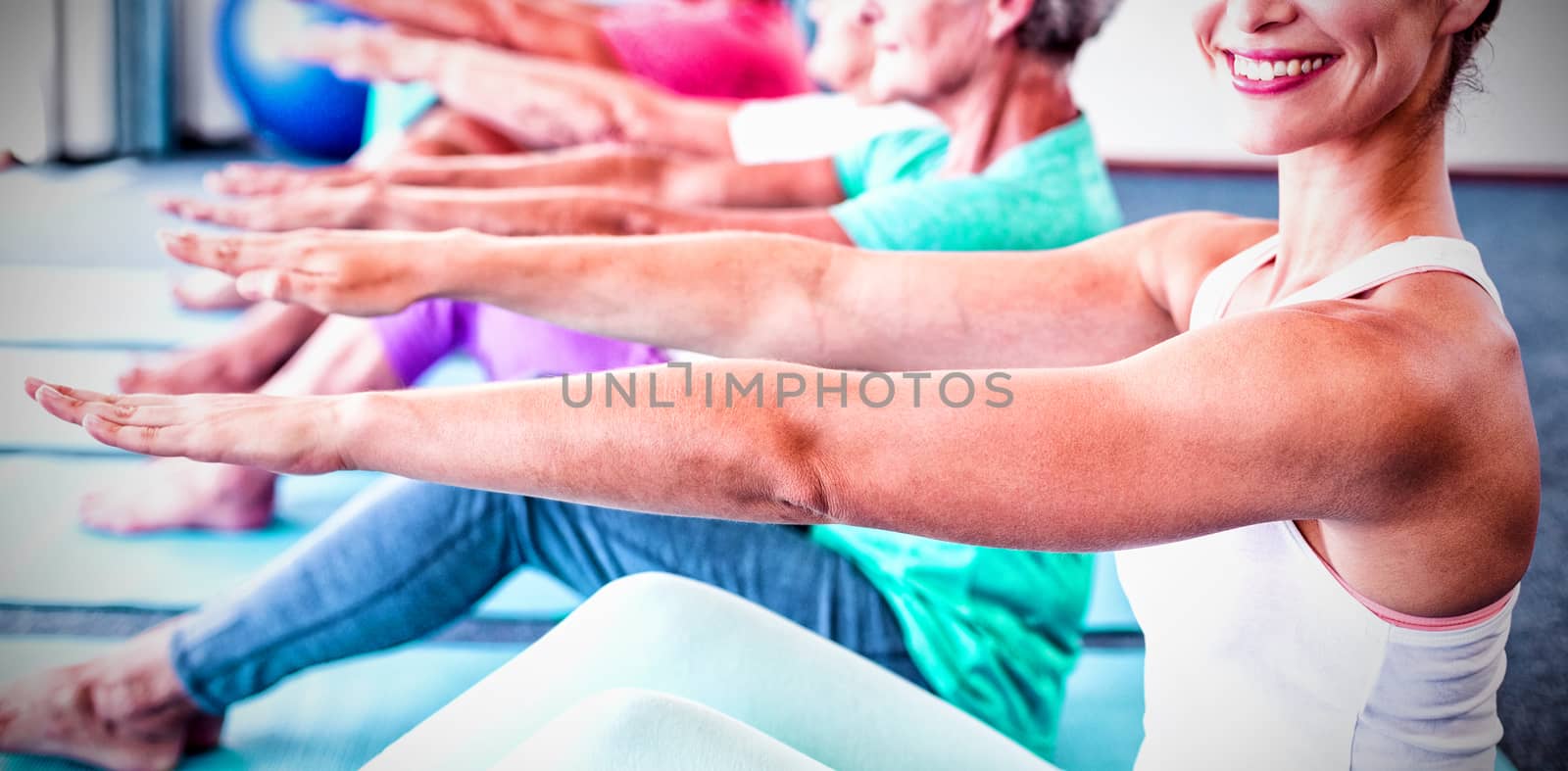 Portrait of Instructor performing yoga with seniors by Wavebreakmedia