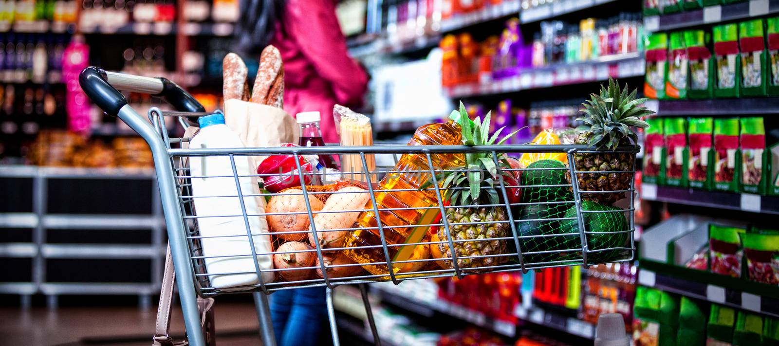 Various groceries in shopping cart by Wavebreakmedia