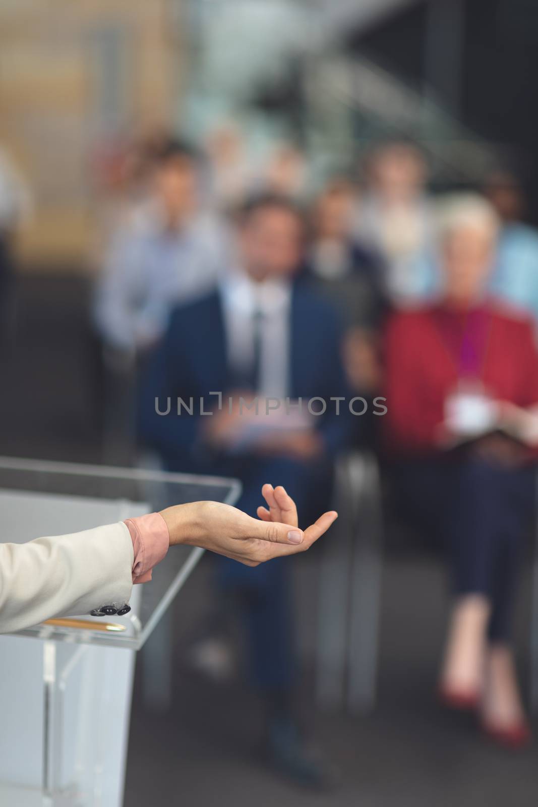 Close-up of mixed race female speaker hand while shes speaking at a business seminar in office