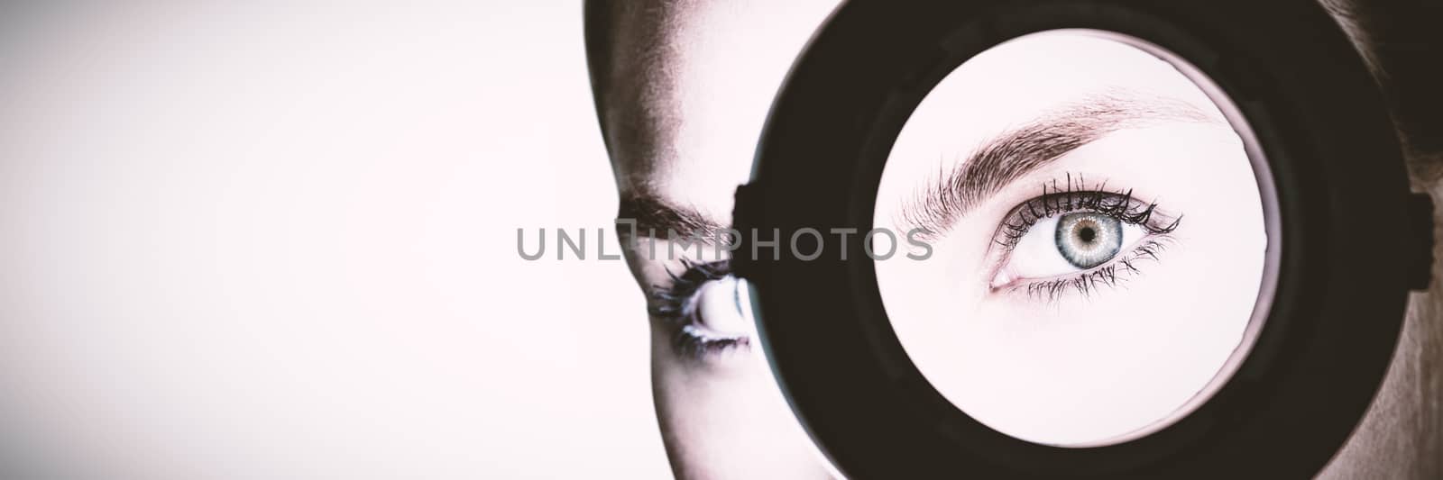 Beautiful woman with hand mirror against white background by Wavebreakmedia