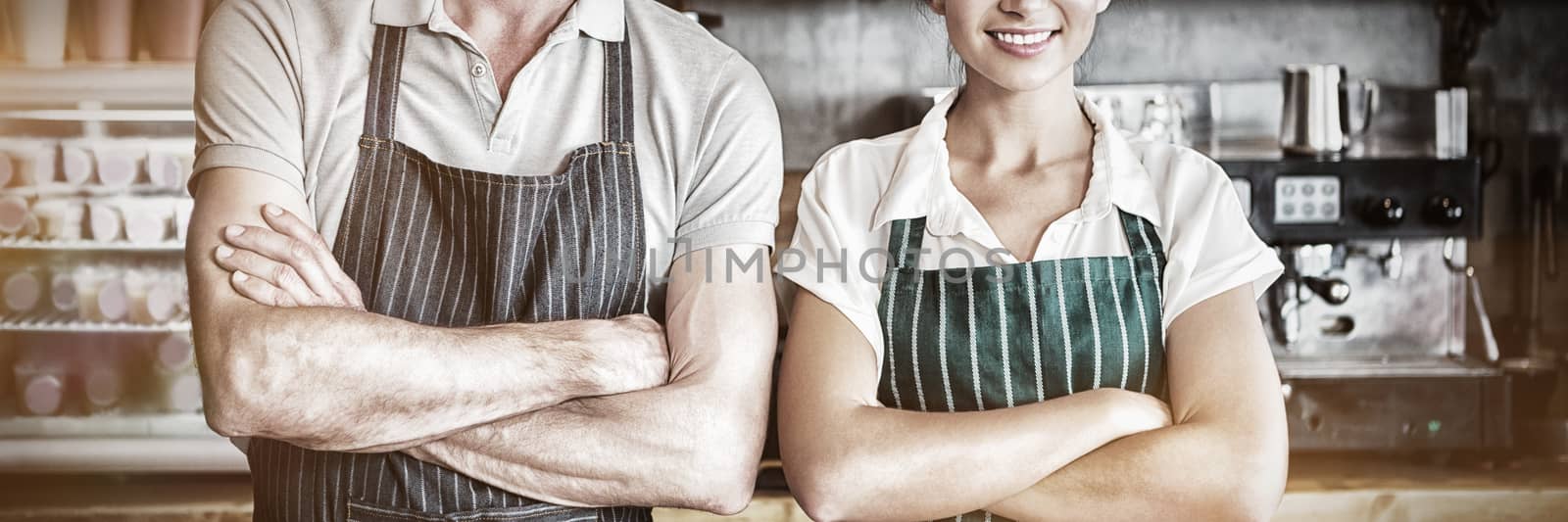 Portrait of waiter and waitress with arms crossed by Wavebreakmedia