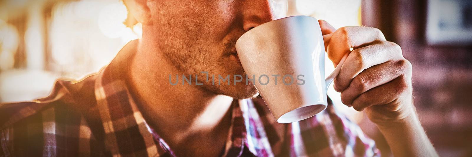 Man drinking a cup of coffee in the cafe