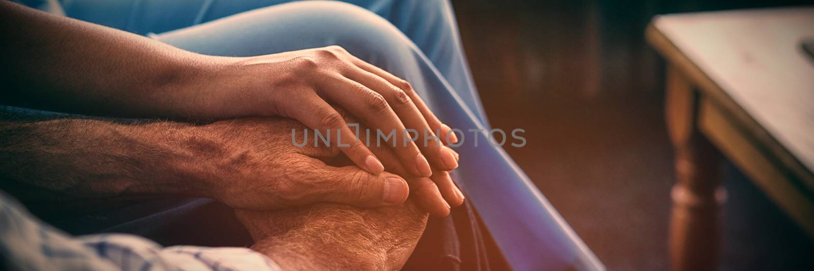 Cropped image of female doctor consoling senior man in nursing home