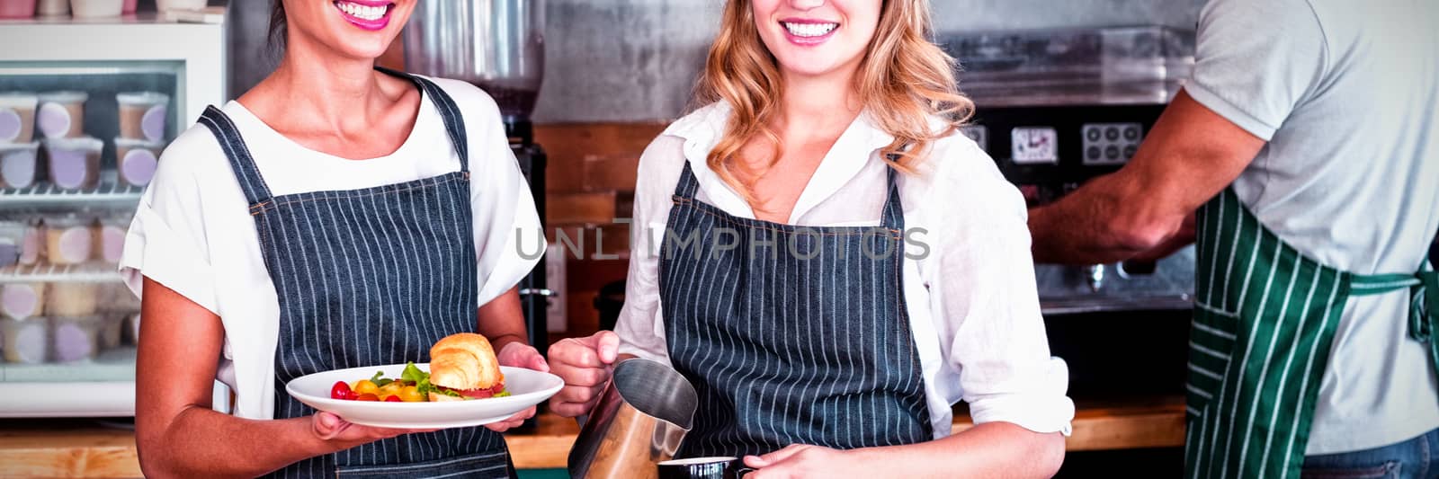 Portrait of smiling colleague working at counter in cafe