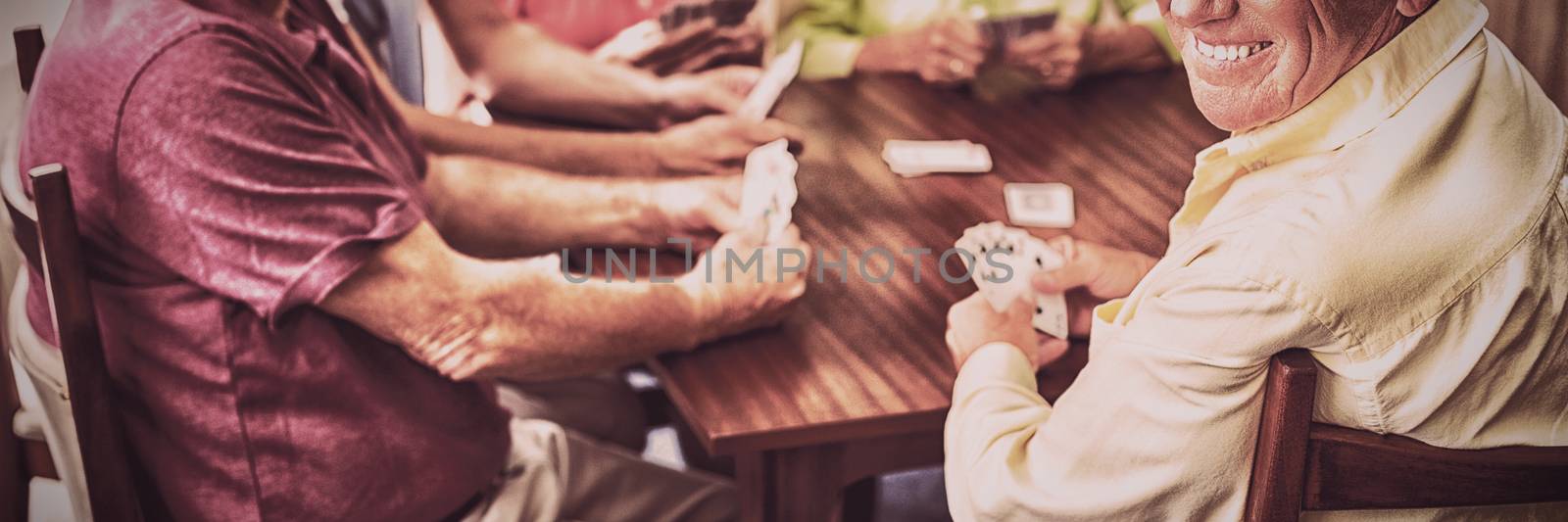 Seniors playing cards together in a retirement home
