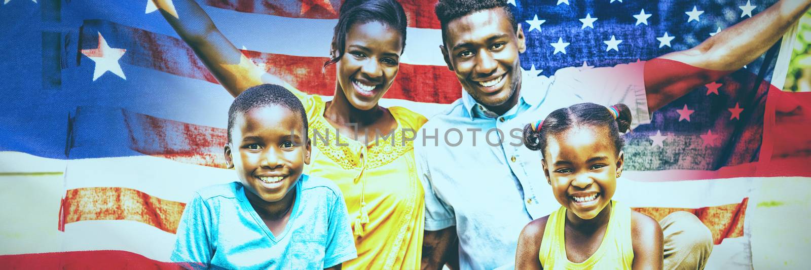 Close-up of an American flag against happy family holding american flag