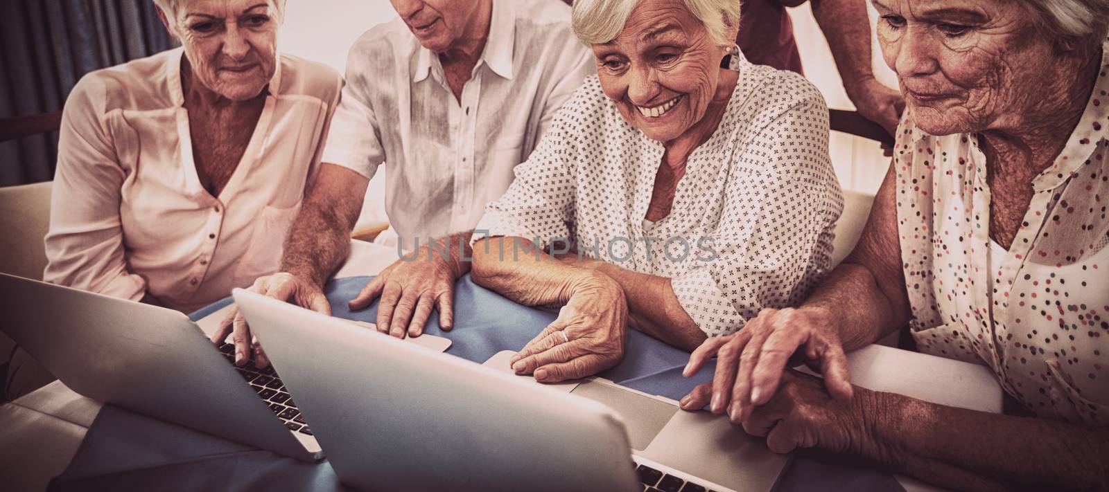 Group of seniors using a laptop in the house