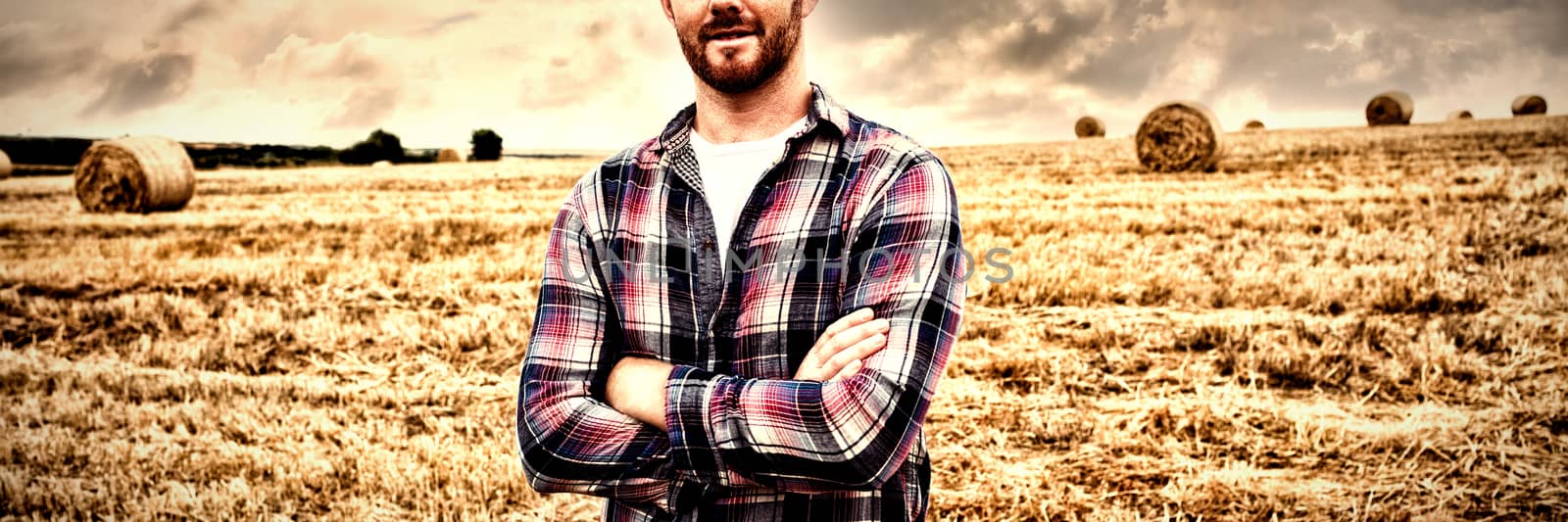 Portrait of farmer standing with arms crossed in the field by Wavebreakmedia