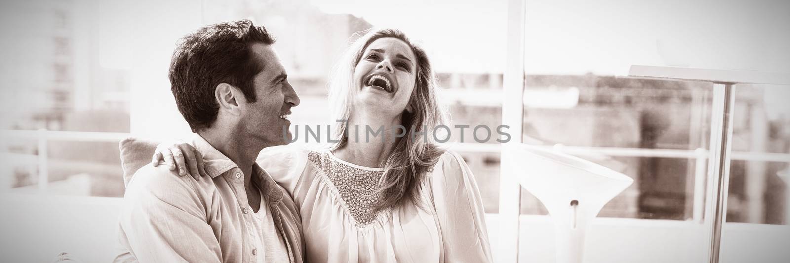 Happy couple relaxing on sofa at home