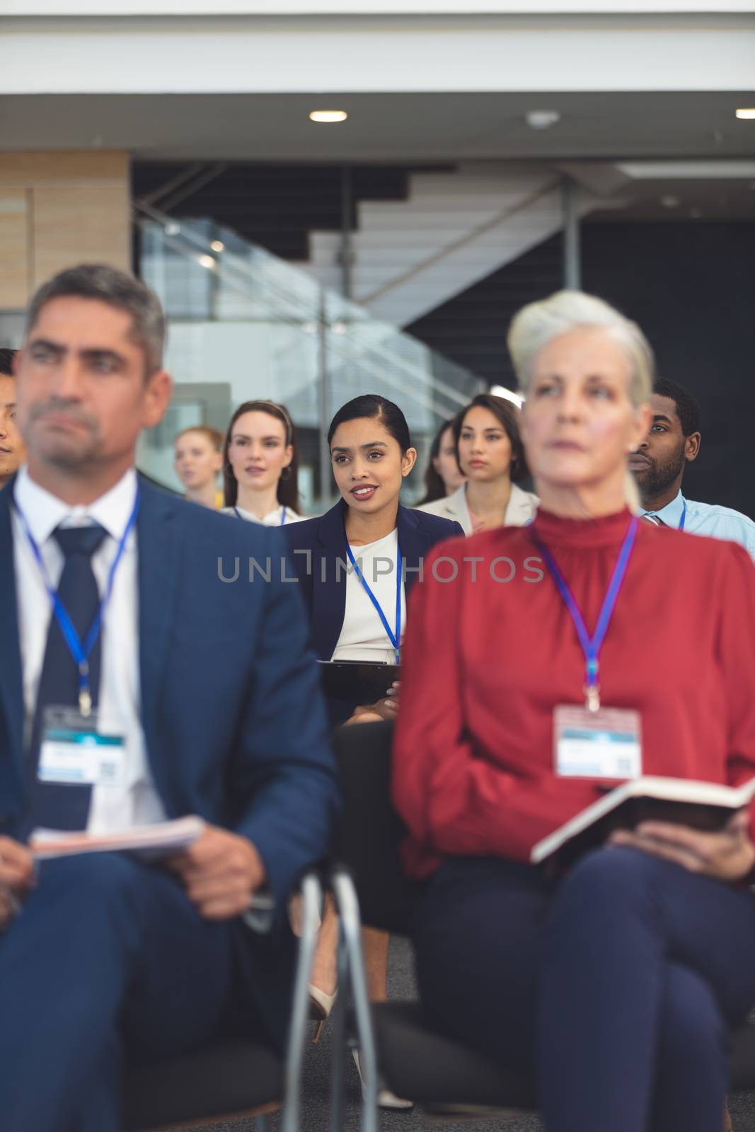 Front view of beautiful young mixed race businesswoman at a business seminar in office building