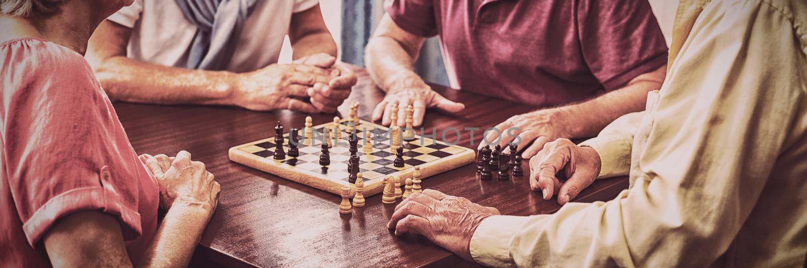 Seniors playing chess in a retirement home