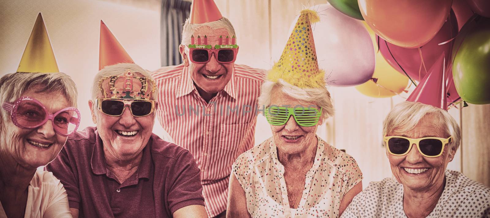 Group of seniors celebrating a birthday by Wavebreakmedia