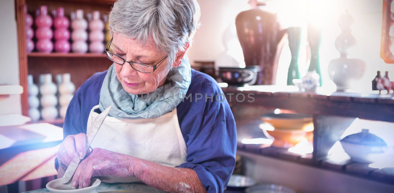 Female potter making pot in pottery workshop