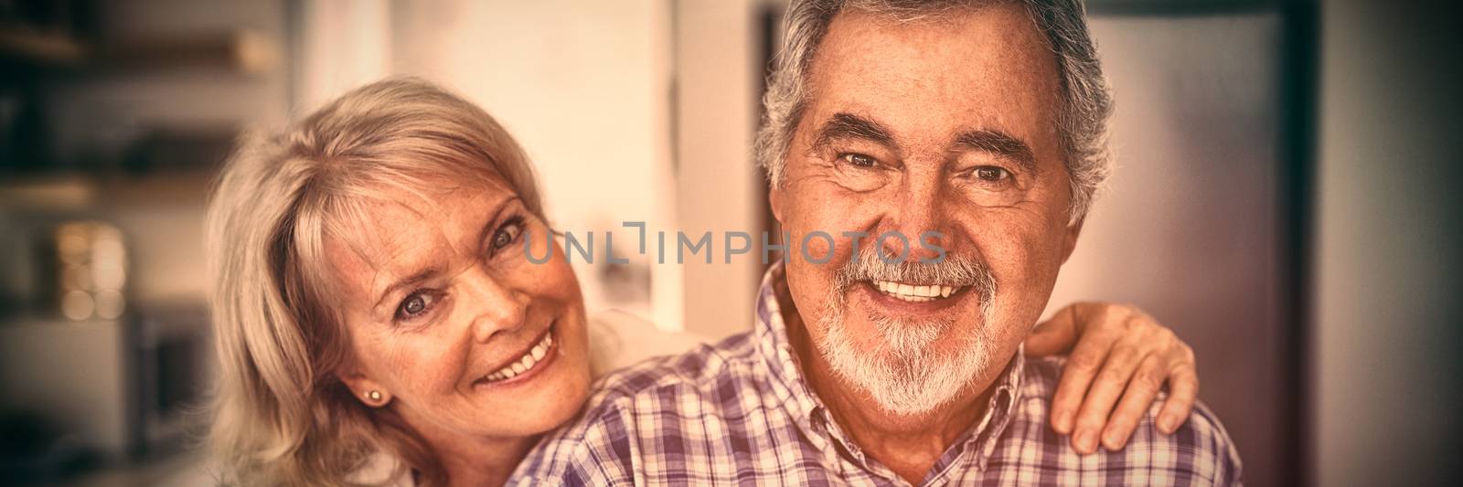 Portrait of senior couple hugging each other at home