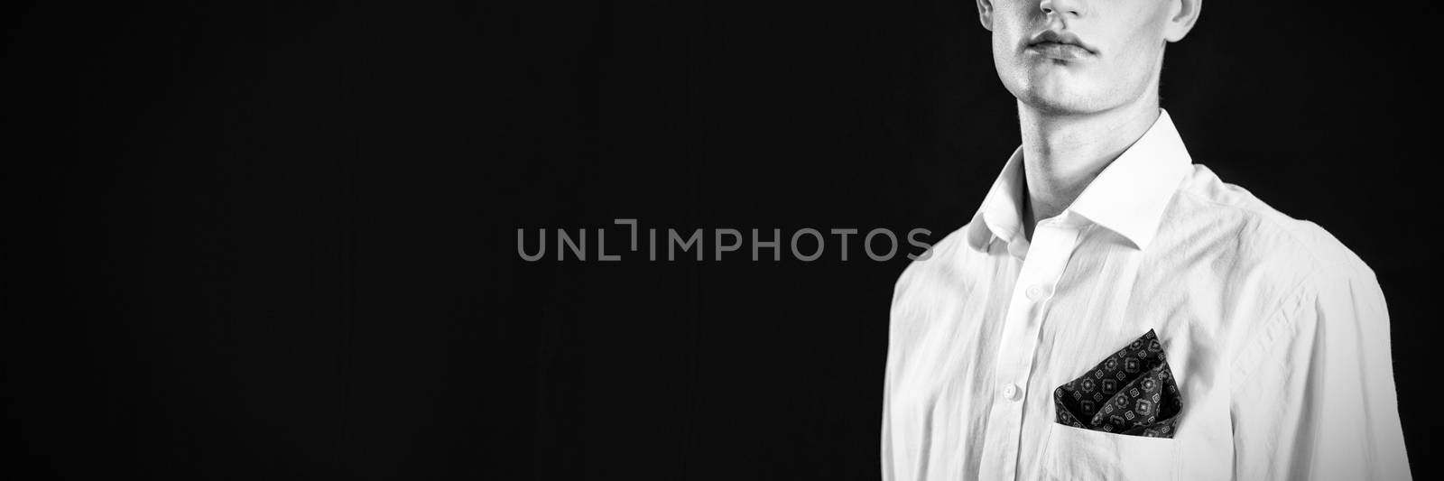 Androgynous man looking at camera against black background