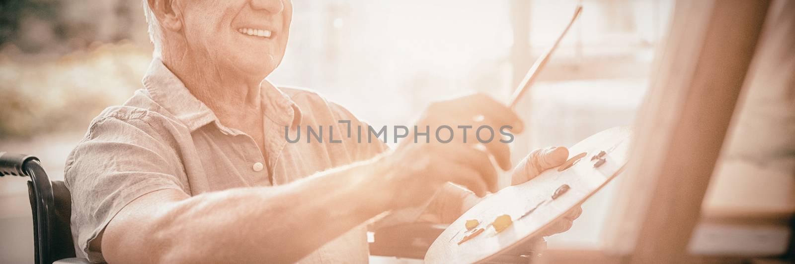 Senior man painting at home by Wavebreakmedia