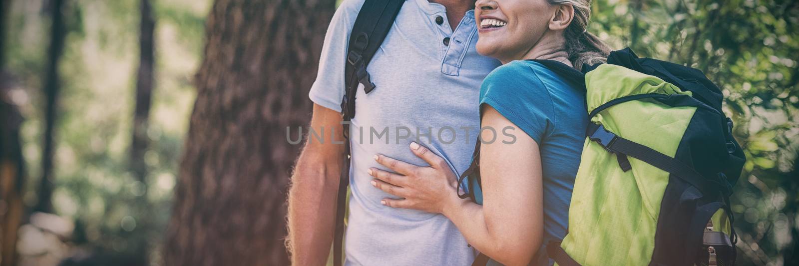 Couple looking something and holding each other by Wavebreakmedia