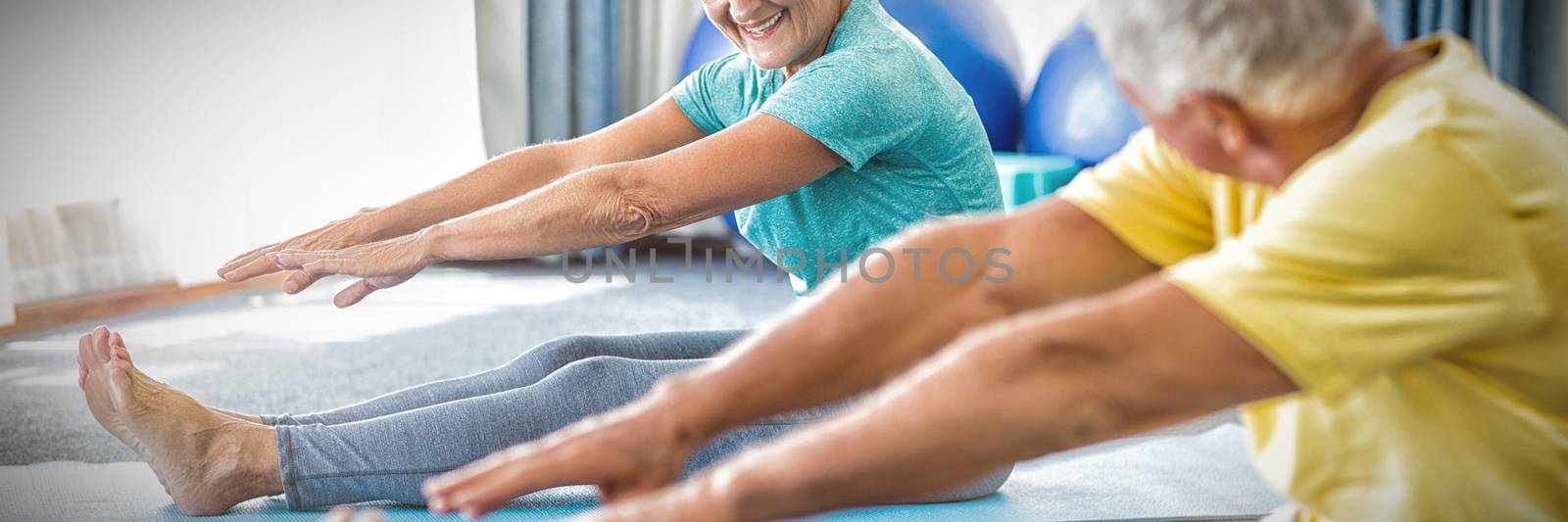 Seniors stretching legs in studio