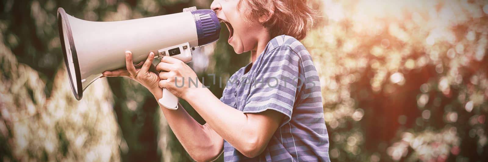 A little boy is screaming with a megaphone by Wavebreakmedia