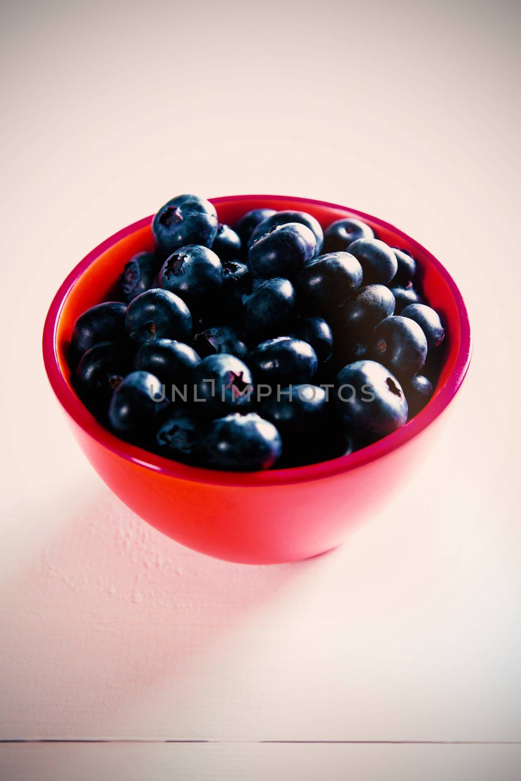 Close-up of blueberries in orange bowl on table