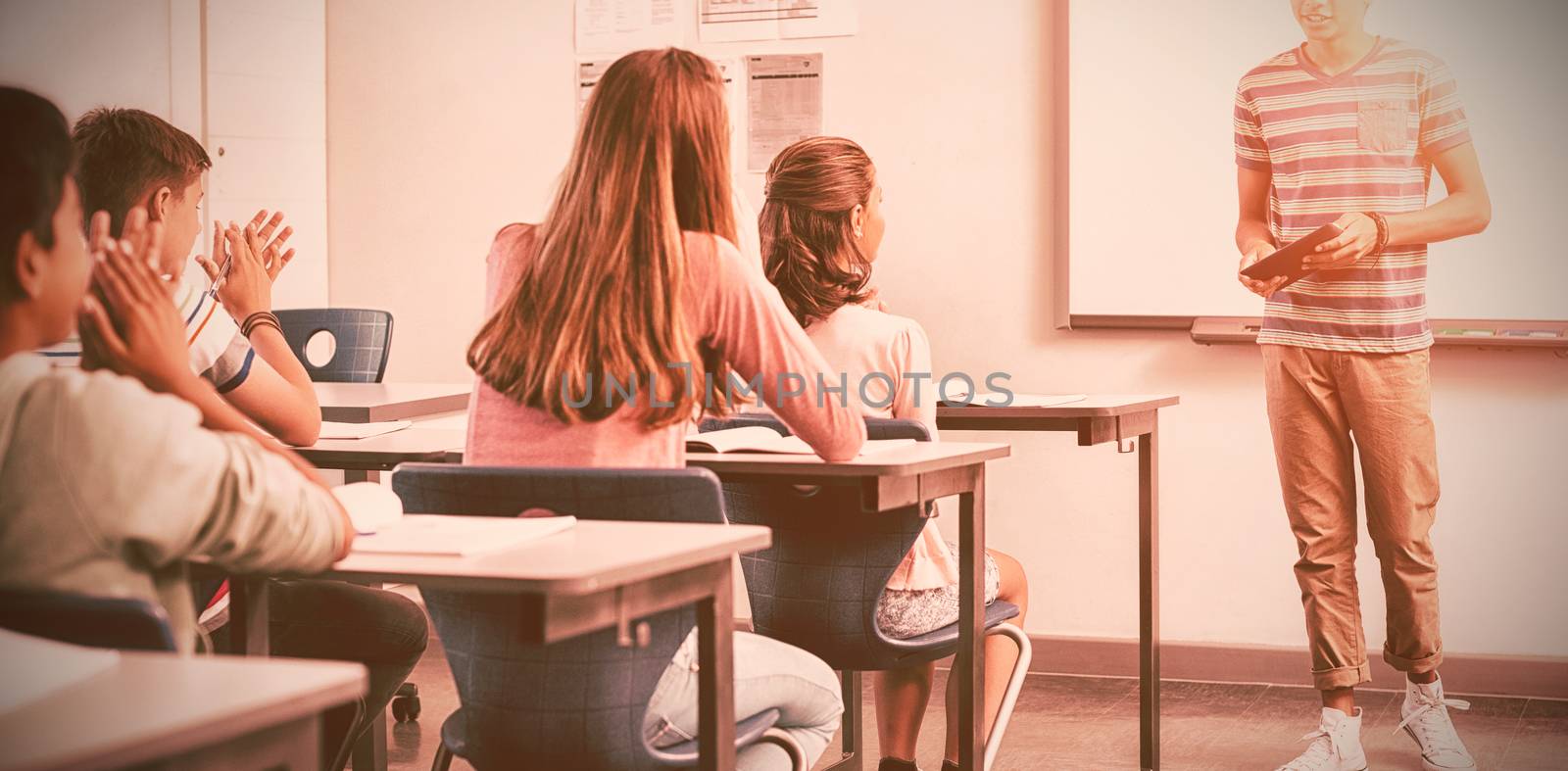 Schoolboy giving presentation in classroom at school