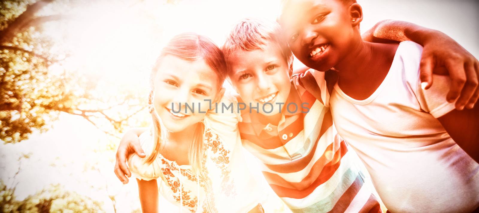 Kids posing together during a sunny day at camera at park