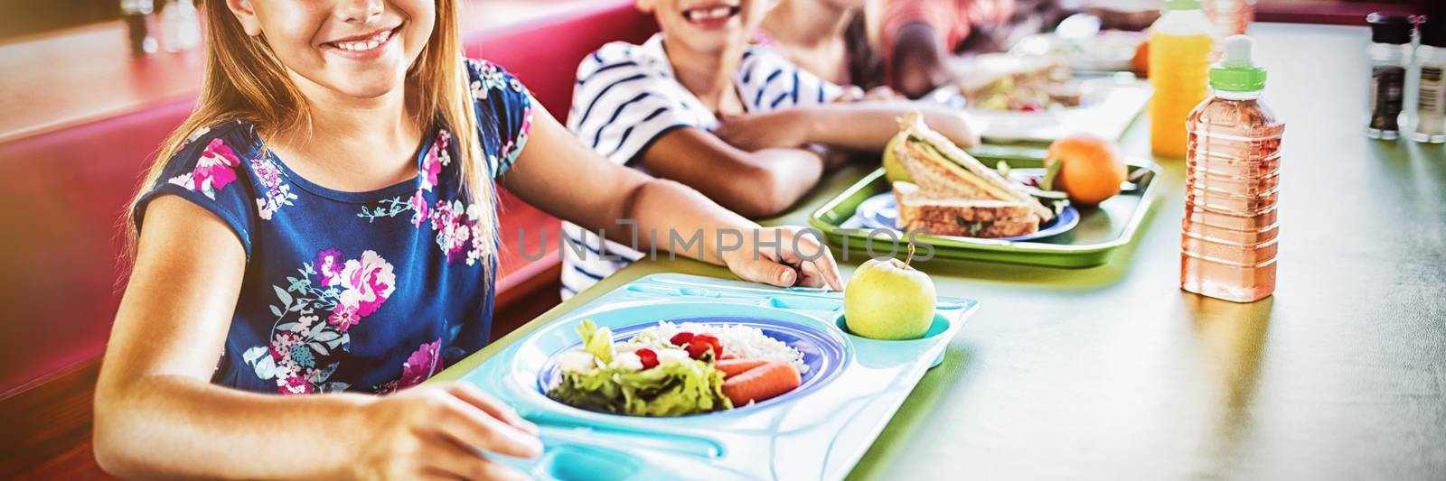 Children eating at the canteen  by Wavebreakmedia
