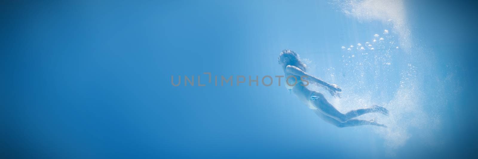 Fit woman swimming under water by Wavebreakmedia