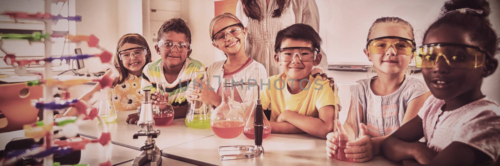 Happy class posing for the camera during science lesson