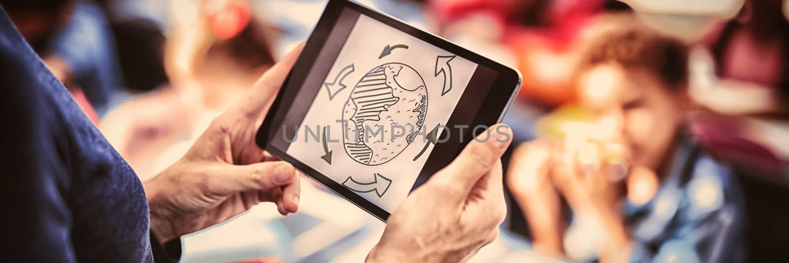 Teacher using digital tablet while teaching in classroom by Wavebreakmedia
