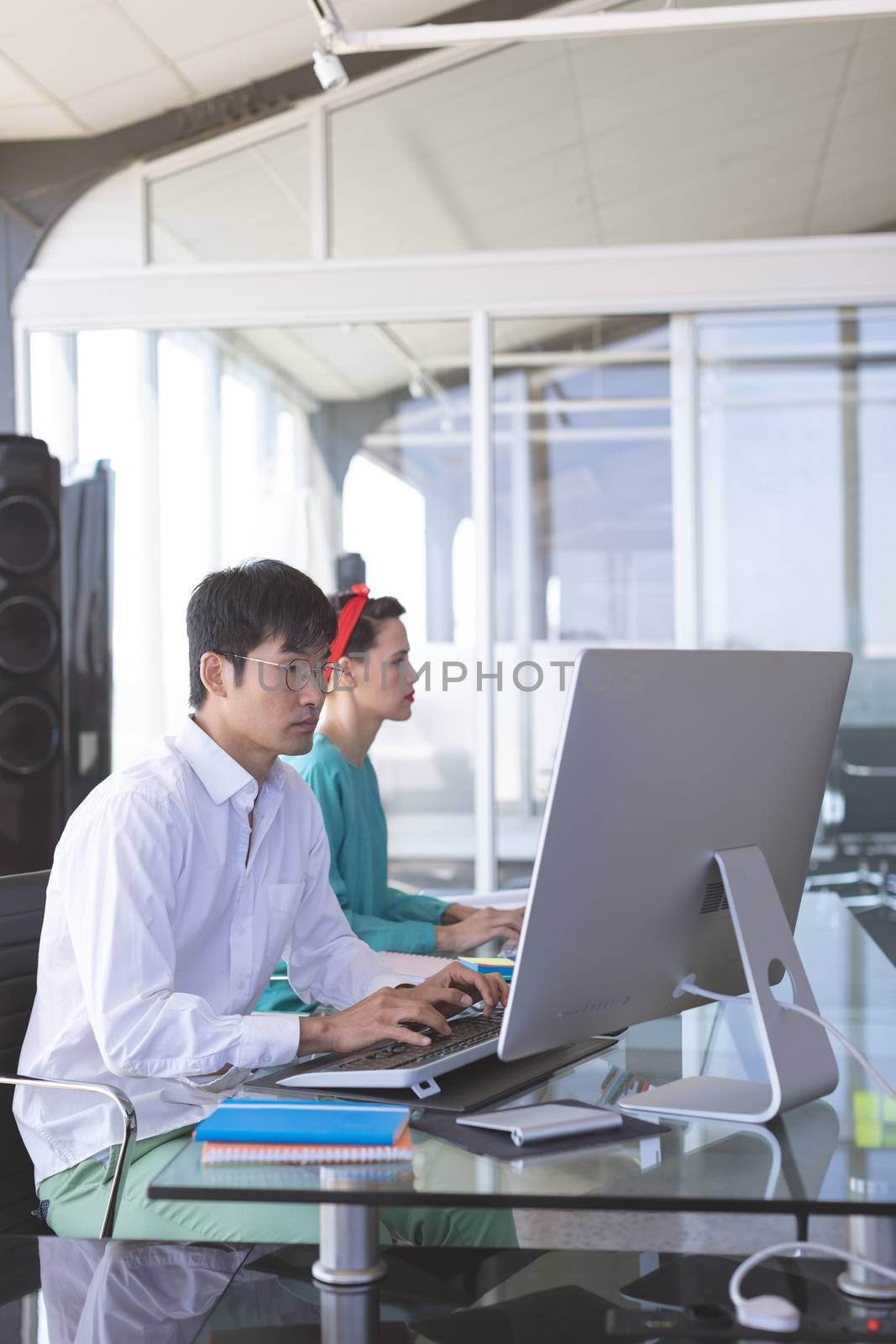 Business people working on computer at desk in office by Wavebreakmedia