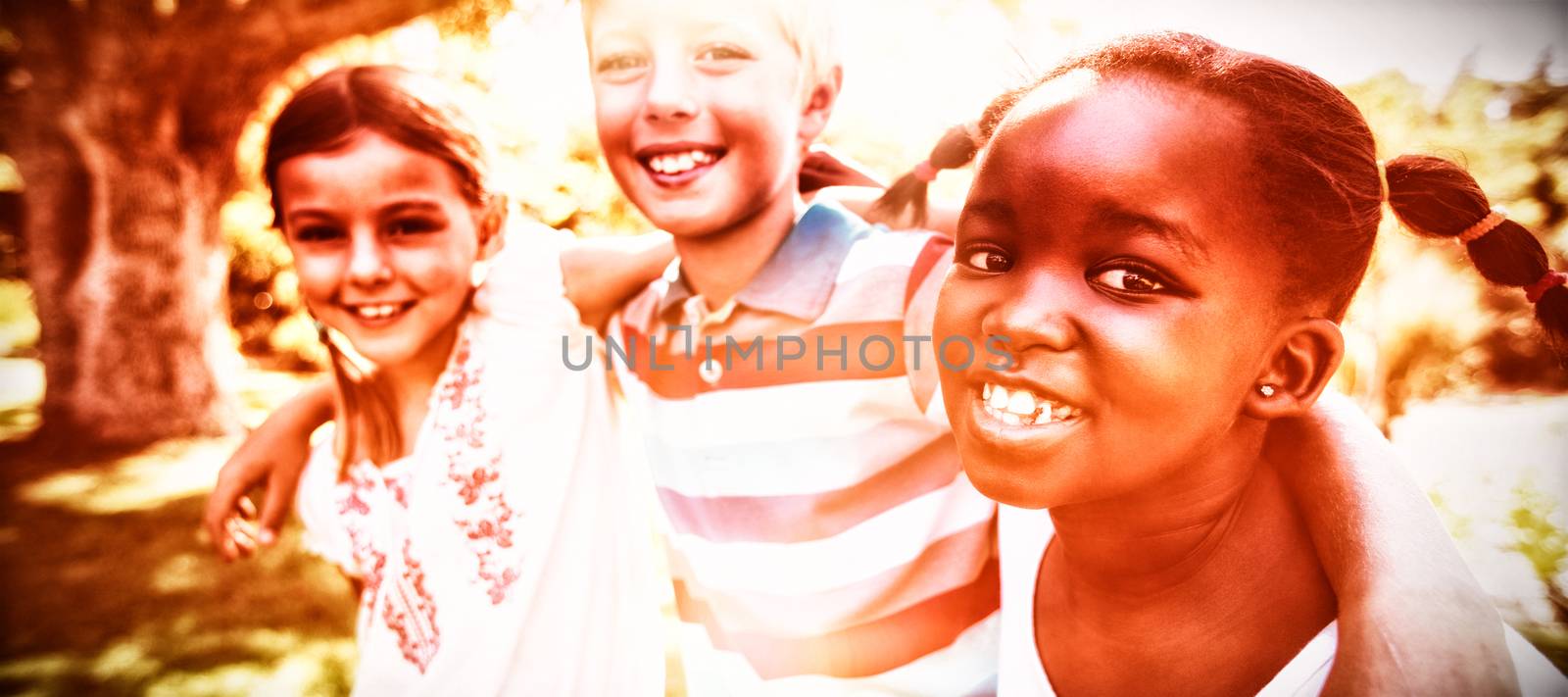 Kids posing together during a sunny day at camera in the park