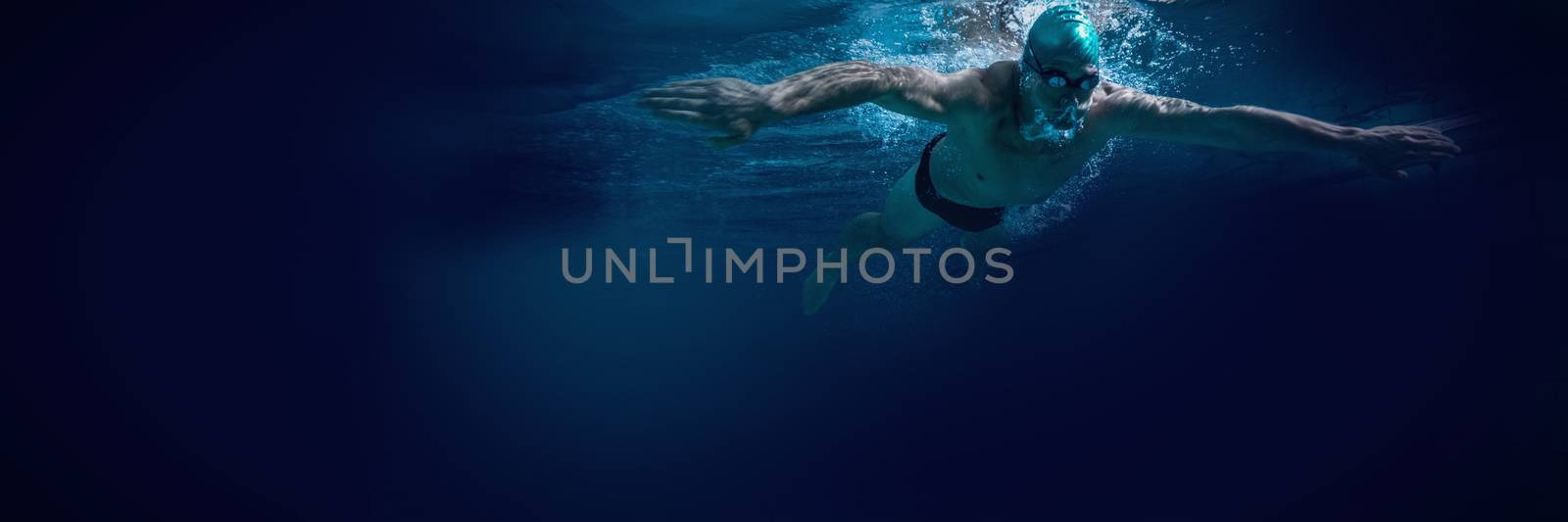 Fit swimmer training by himself by Wavebreakmedia