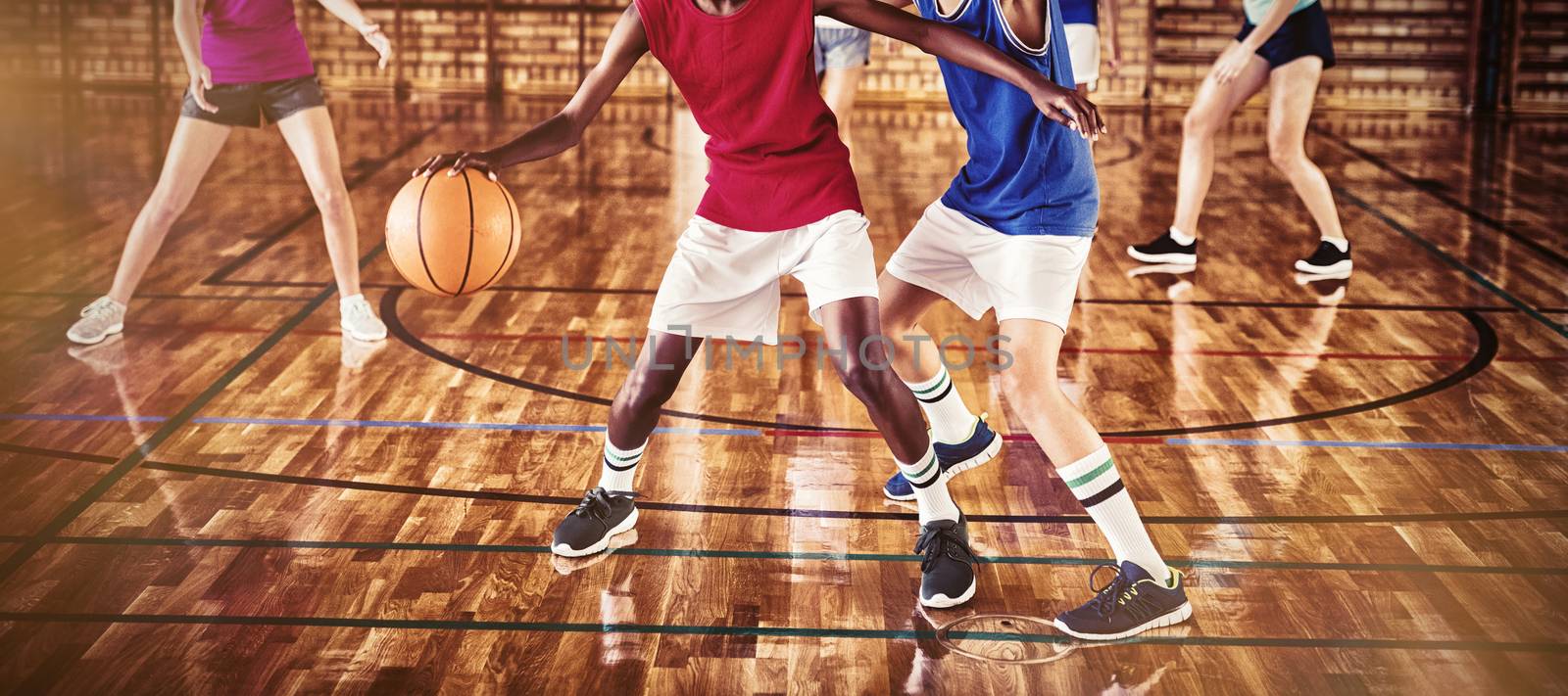 High school kids playing basketball in the court by Wavebreakmedia