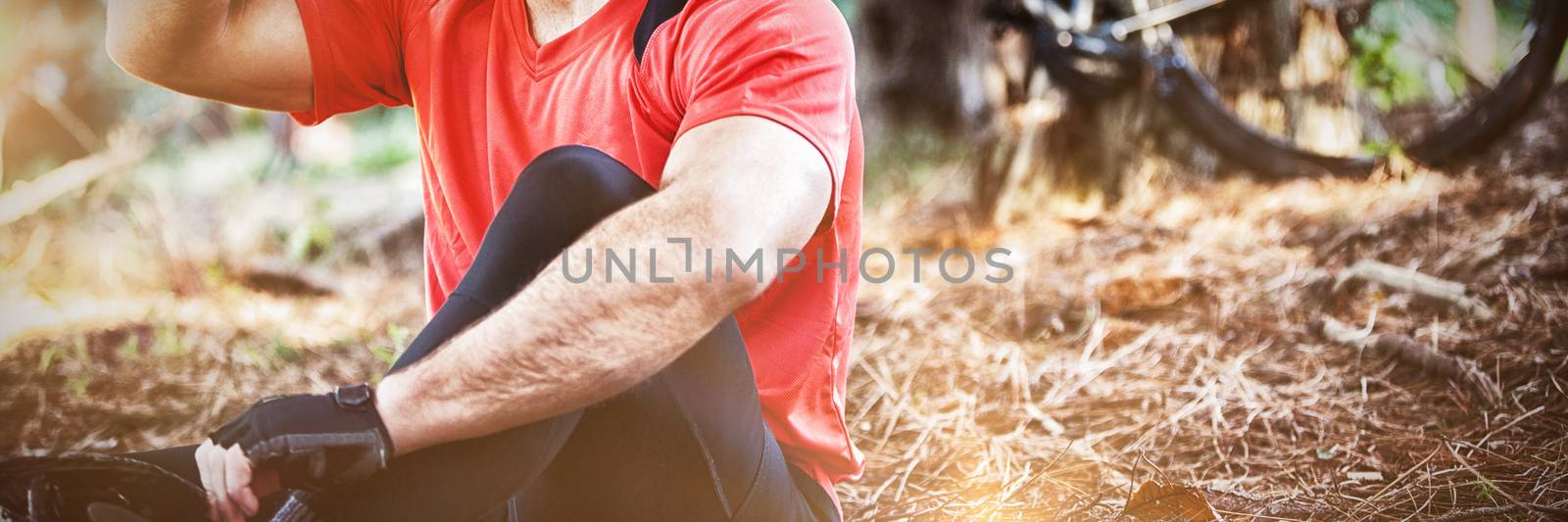 Male mountain biker drinking water in the forest