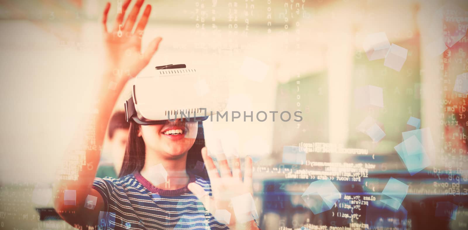 Schoolgirl using virtual reality headset in classroom at school