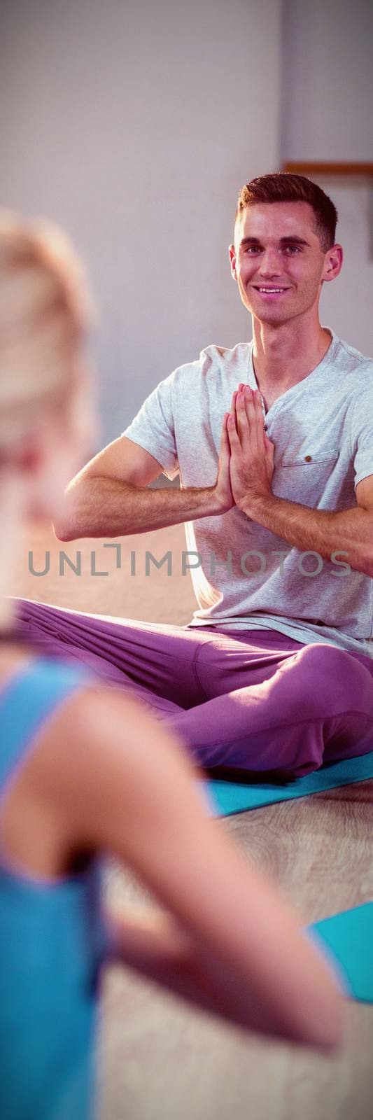 Instructor taking yoga class in fitness studio