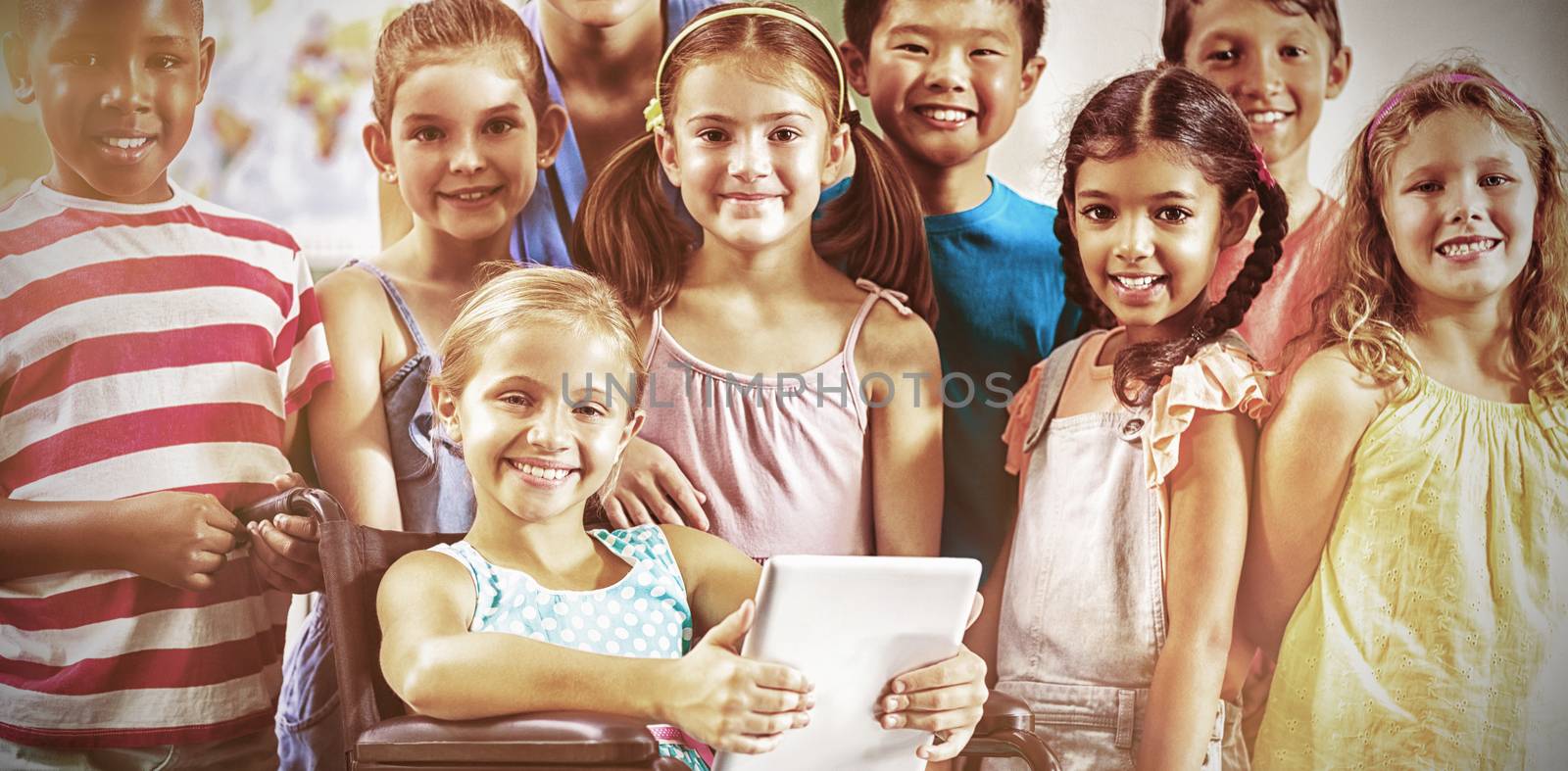 Portrait of teacher and kids in classroom at school