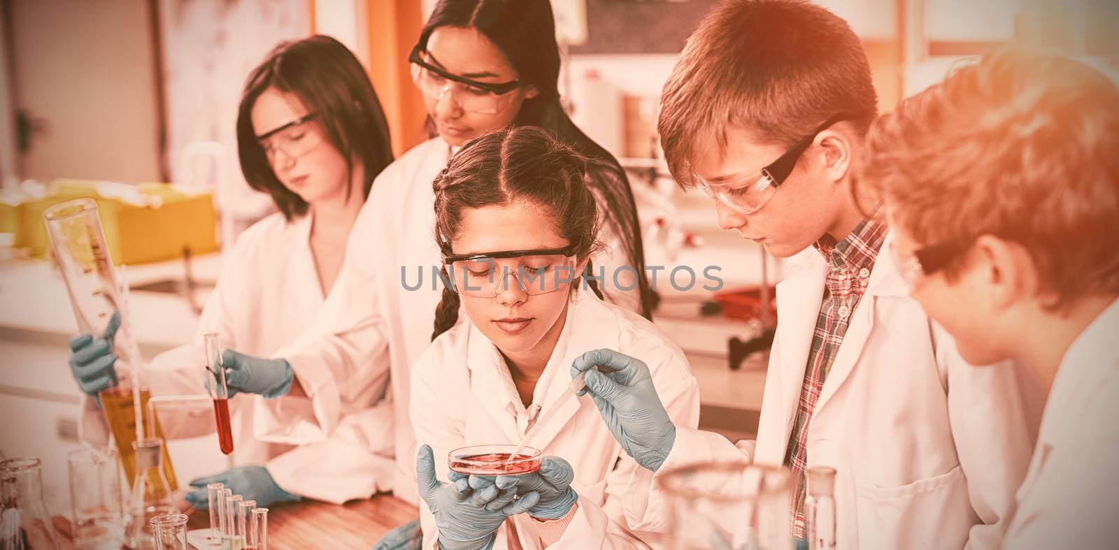 Attentive school kids doing a chemical experiment in laboratory by Wavebreakmedia