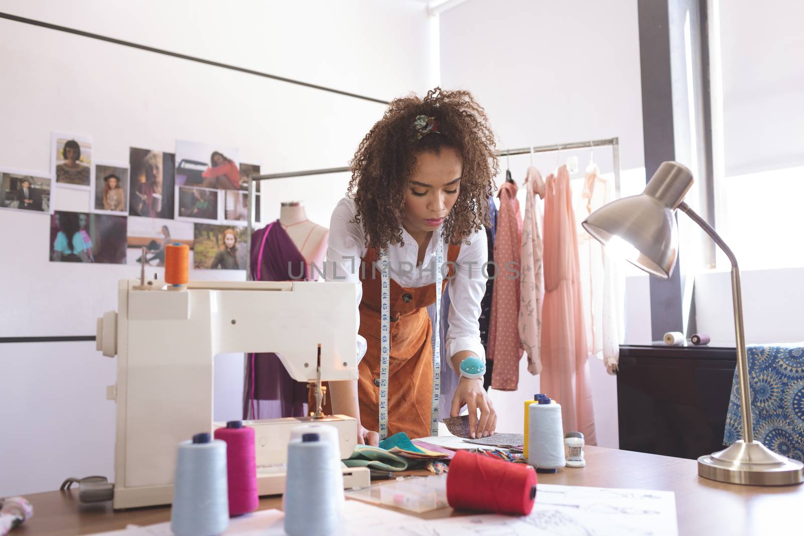 Front view of female fashion designer working in design studio