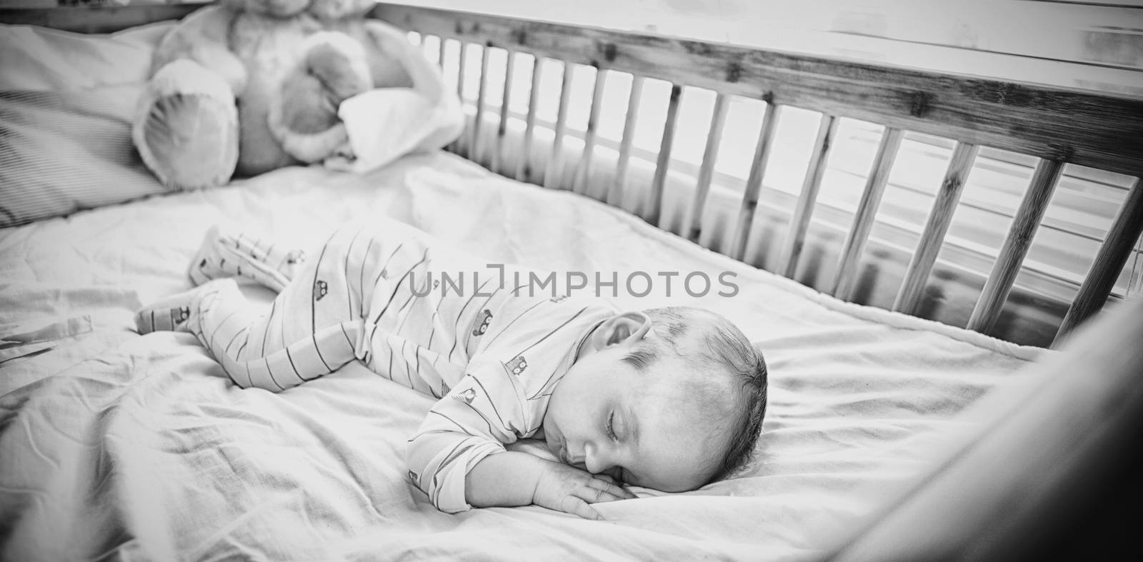 Baby boy sleeping on a cradle at home