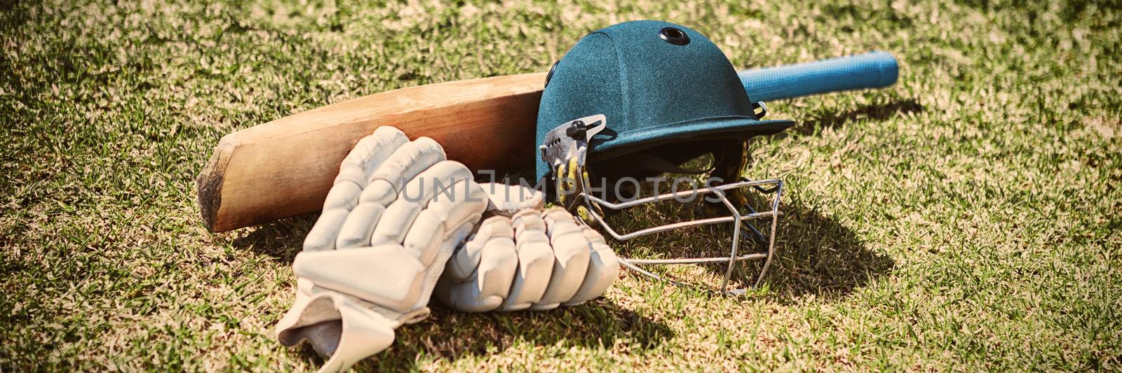 High angle view of cricket equipment on field during sunny day