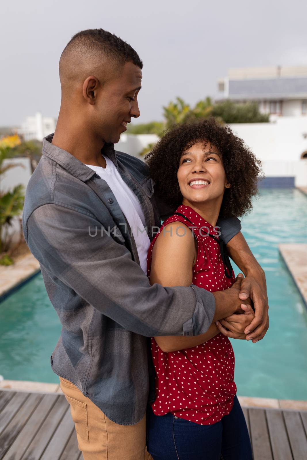 Couple embracing each other near swimming pool at home by Wavebreakmedia