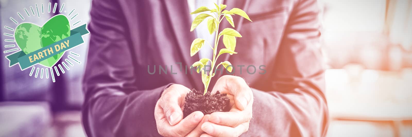 Earth Day Graphic against mid section of businessman holding plant