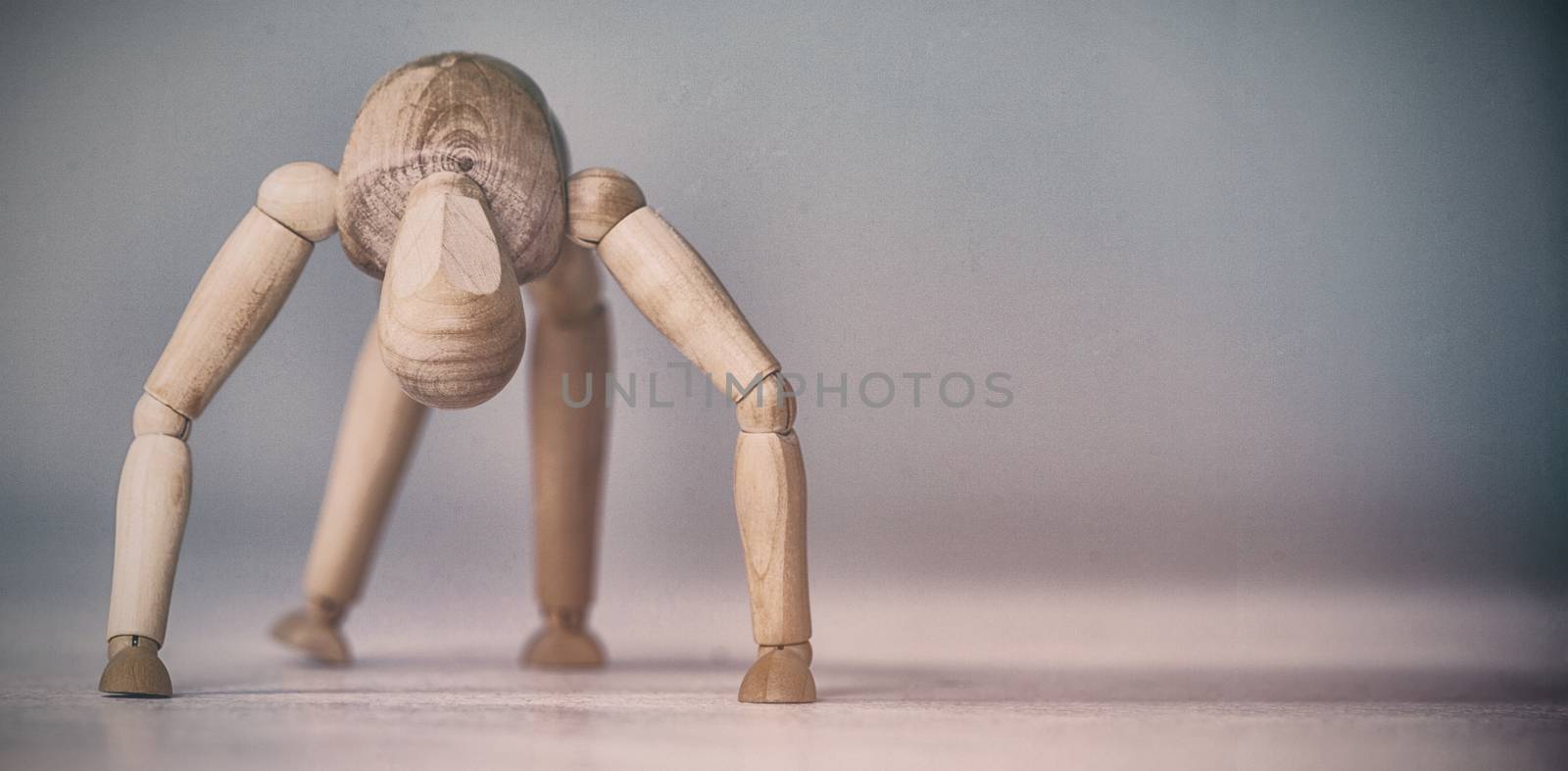 Brown 3d figurine exercising on floor against white background