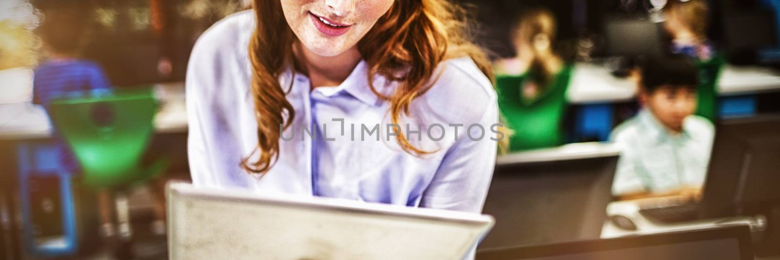 Teacher looking on her tablet by Wavebreakmedia