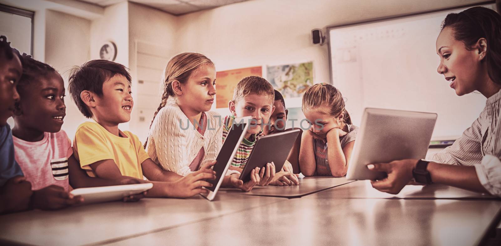 Teacher having lesson with tablet pc in classroom