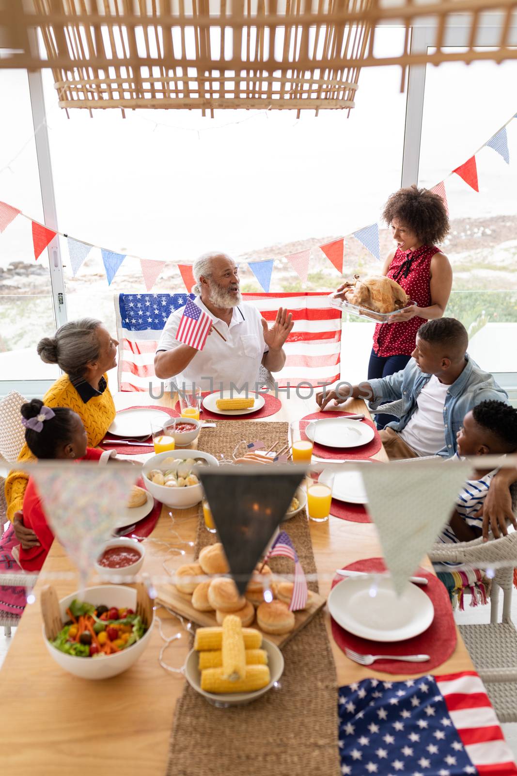 Side view of Multi-generation African American family having food together on a dining table at home