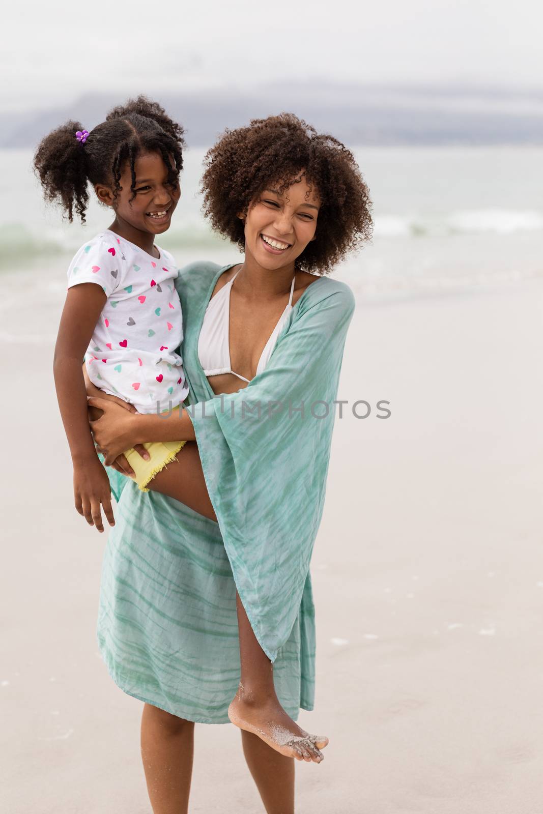 Mother and daughter standing together on a sunny day by Wavebreakmedia